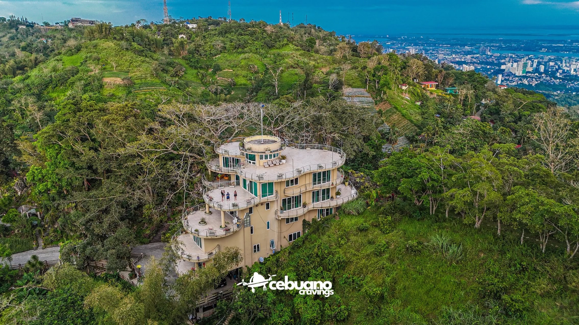 Soul Sierra mansion seen from above the tree line with Cebu City in the distance
